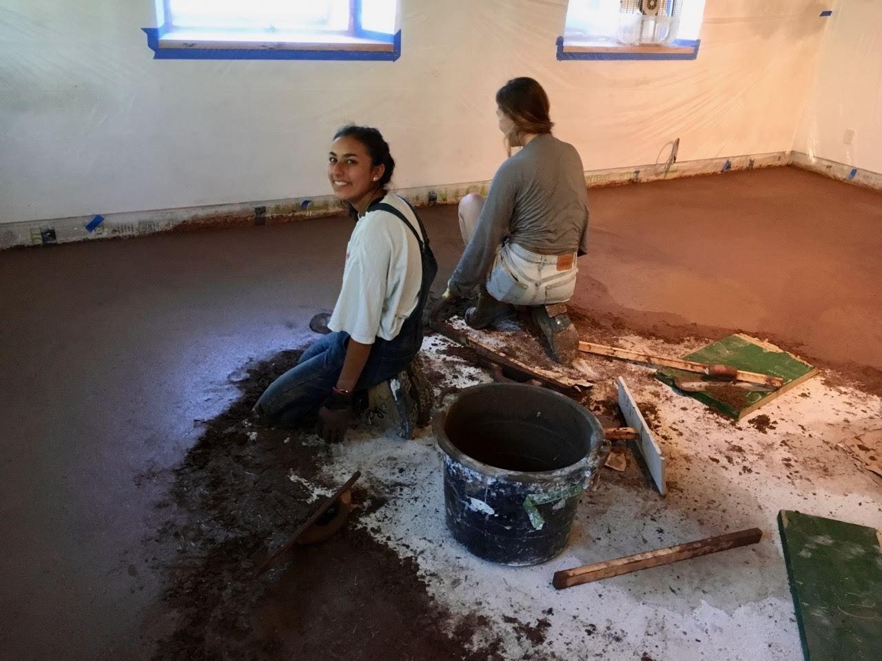 Image of student laying down concrete floor